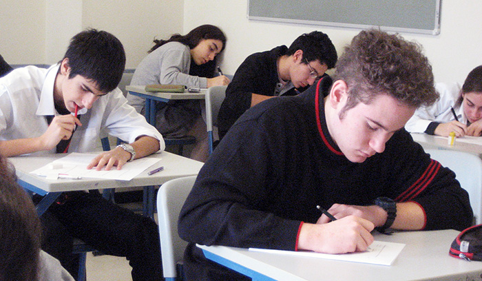 students in class taking exams