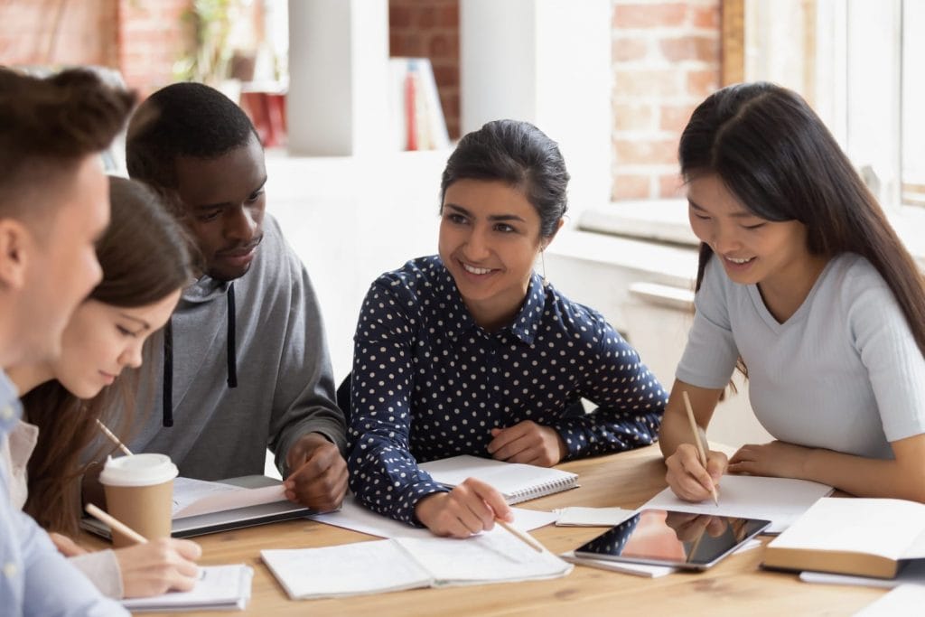 Students at table discussing exam